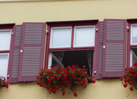 Ventana de color rojo instalada en fachada